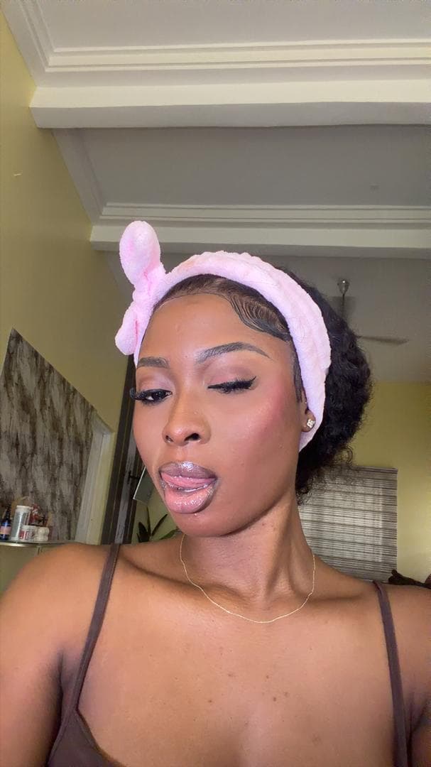 Lina wearing a soft pink lip gloss and nude liner look