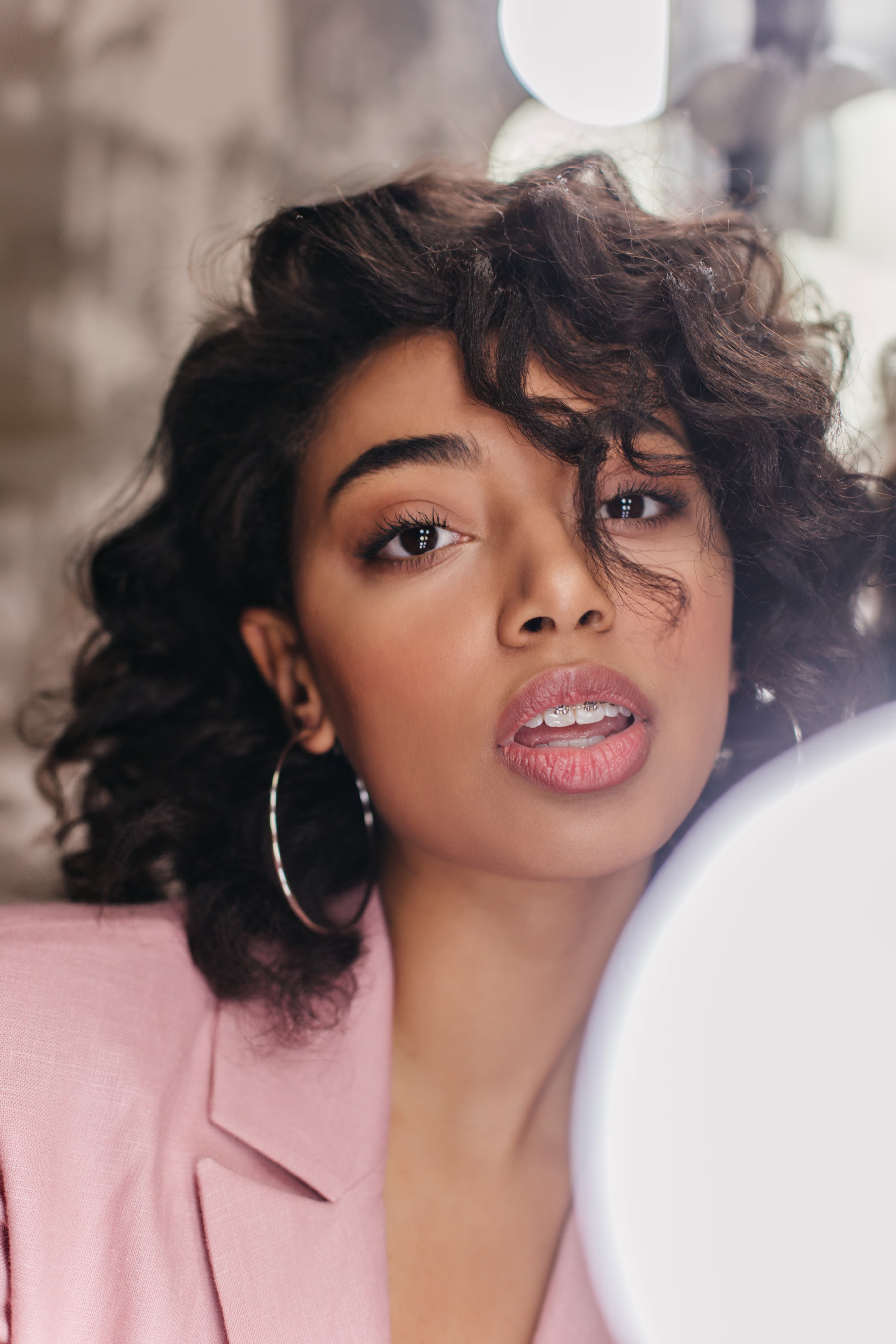 Adwoa wearing a defined brown lip liner with pink gloss